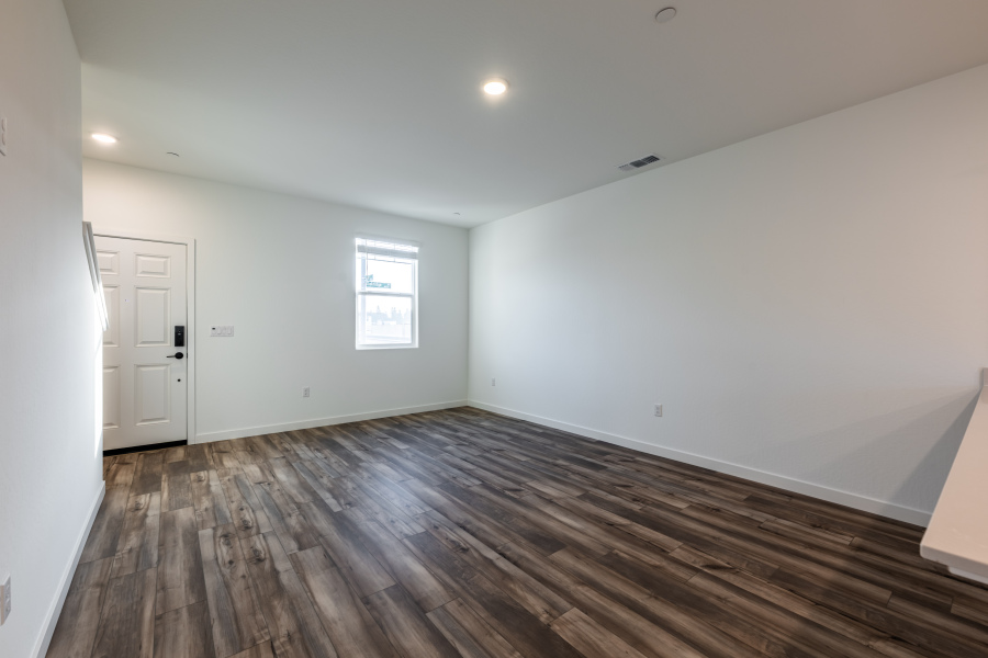 A room with a wood floor and white walls.