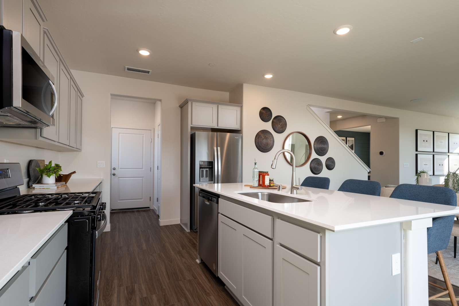 A kitchen with white cabinets.