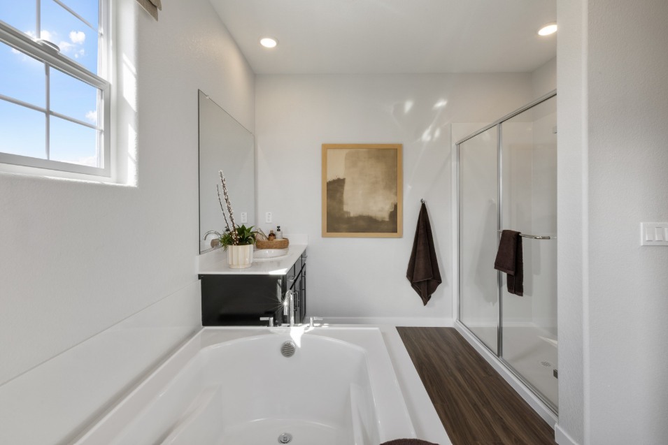 A bathroom with a tub and a shower.