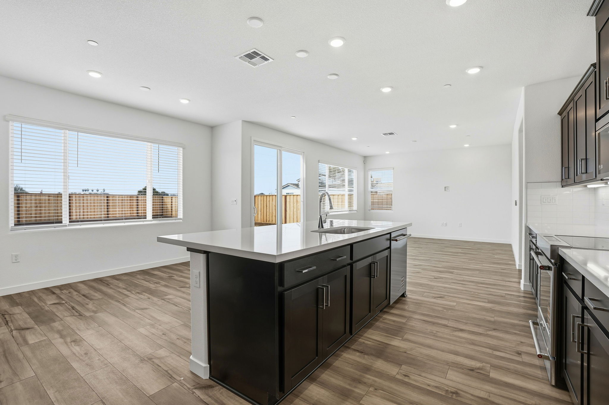 A kitchen with black cabinets.
