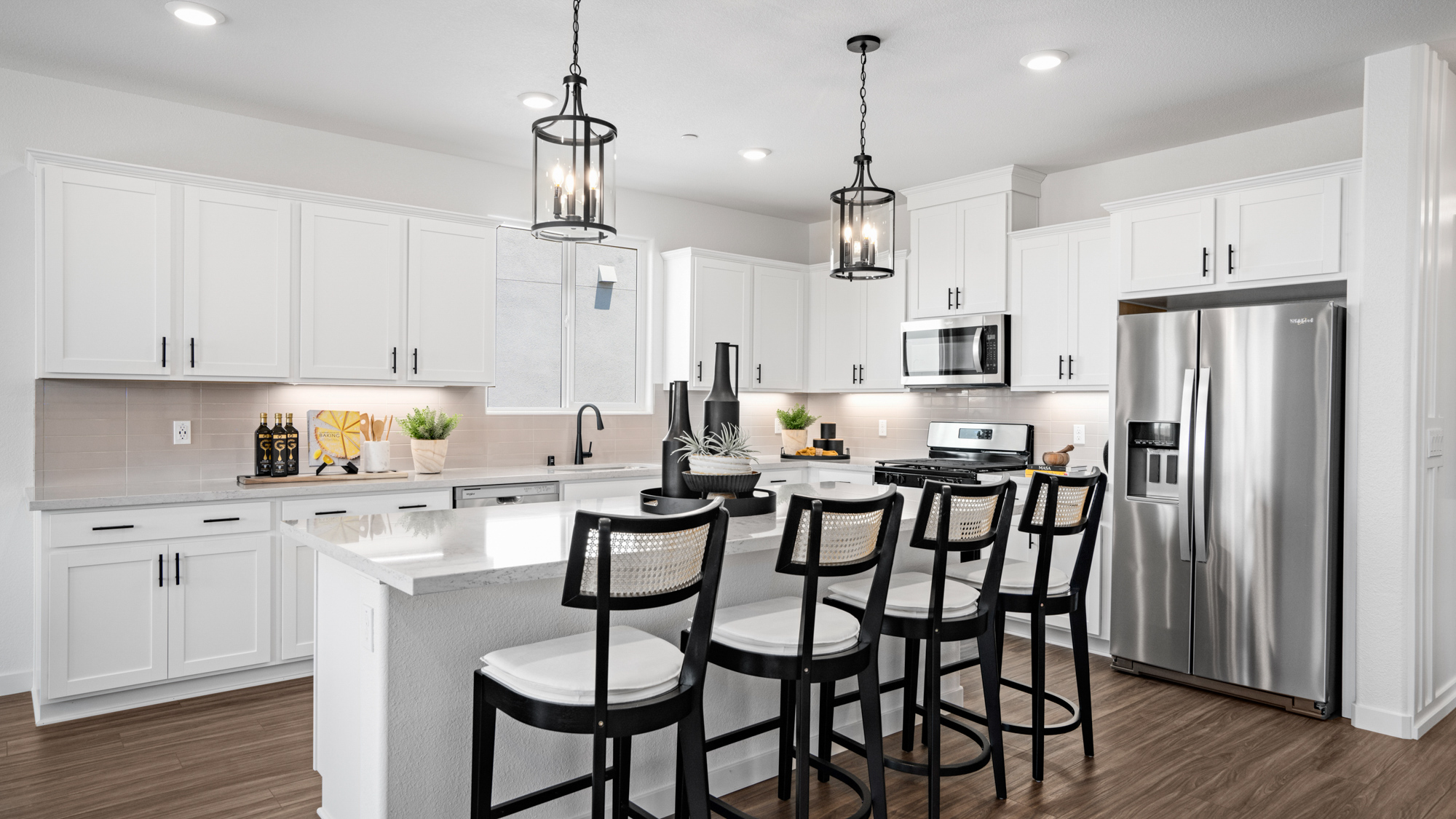 A kitchen with white cabinets.