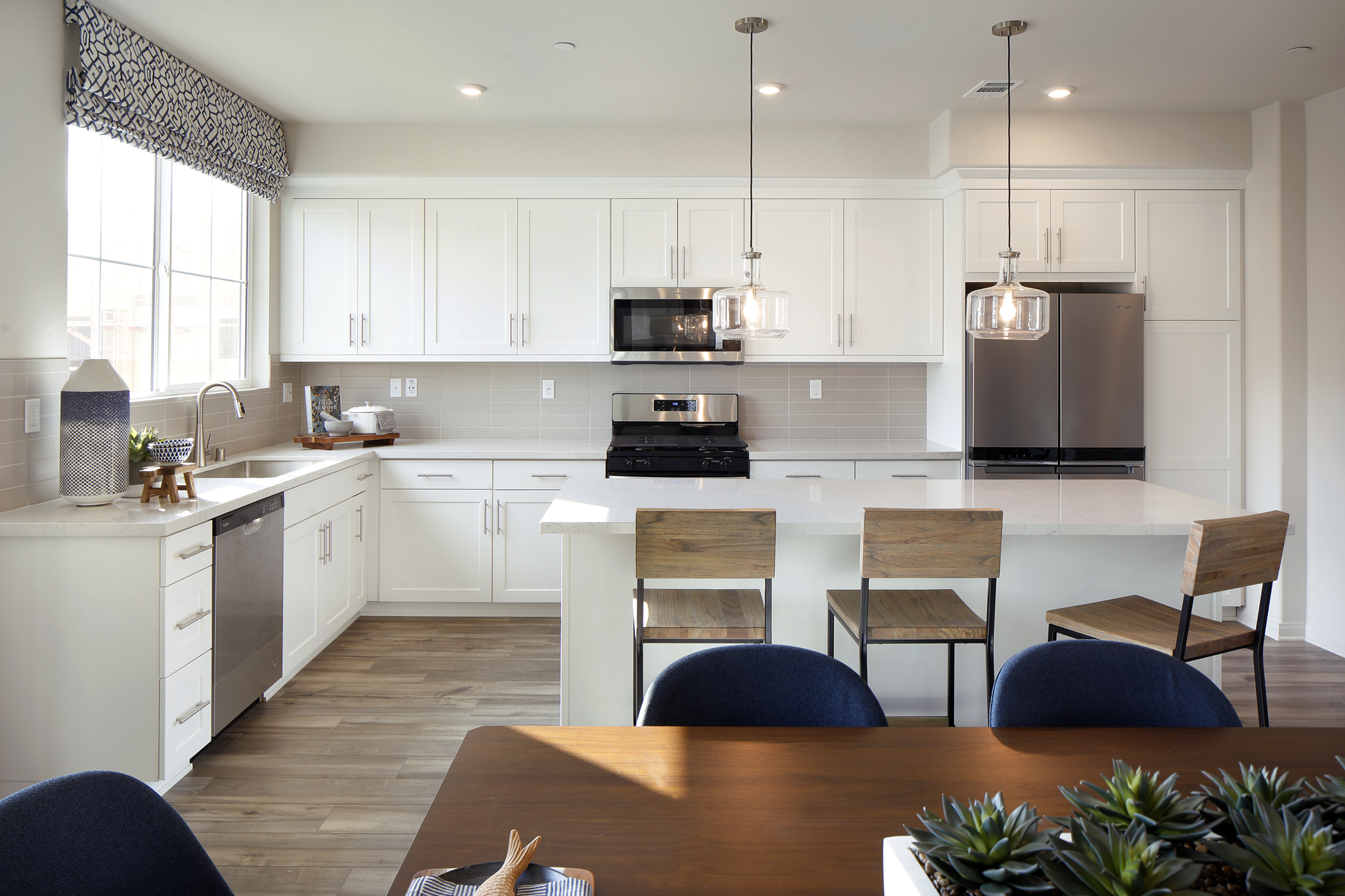 A kitchen with white cabinets.