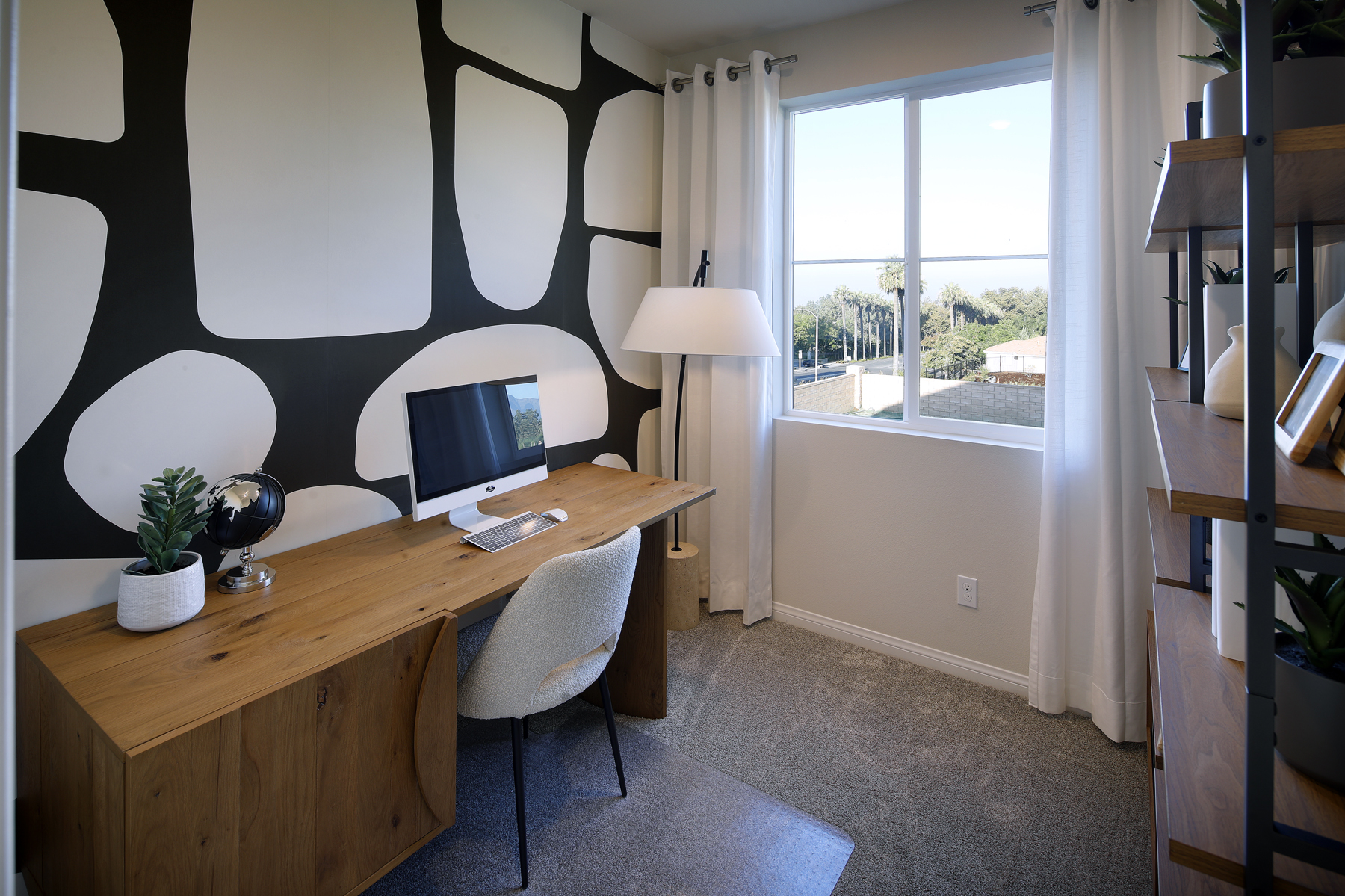 A room with a desk and a window.
