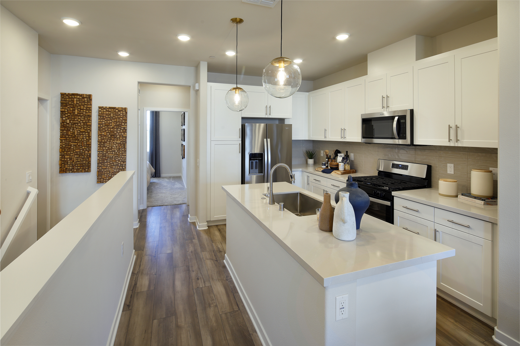 A kitchen with white cabinets.
