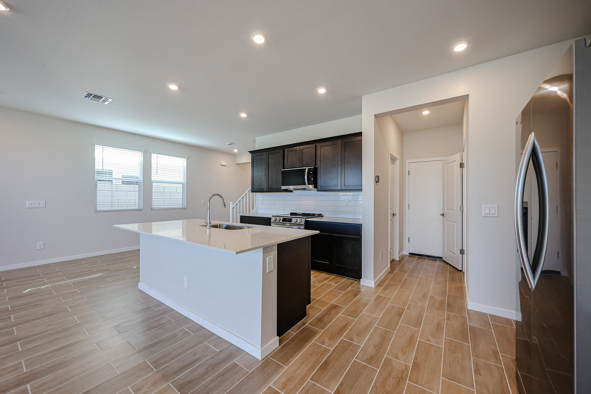 A kitchen with black cabinets.