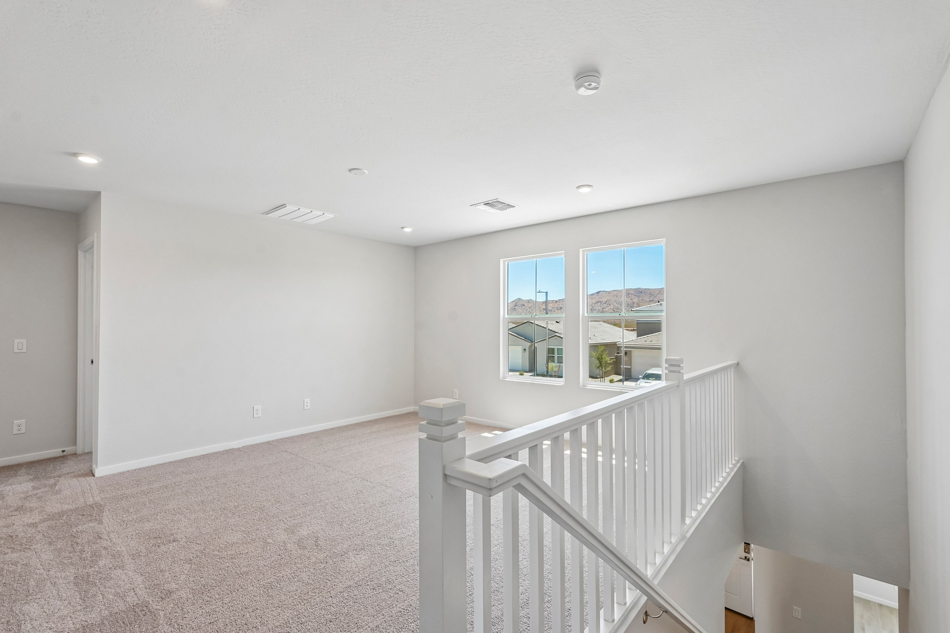 A room with a white railing and a white railing.