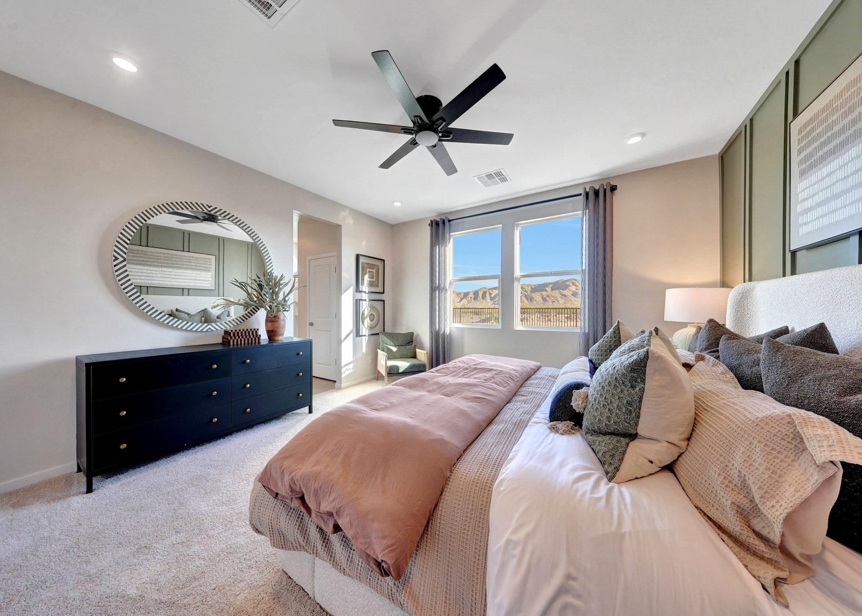 A large living room with a large fan and a large window.