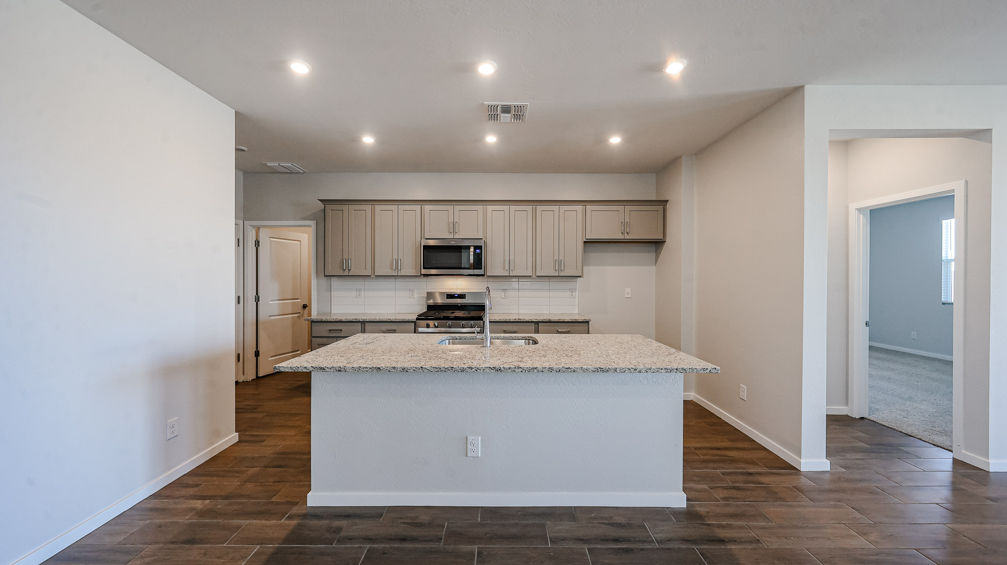 A kitchen with a marble counter top.