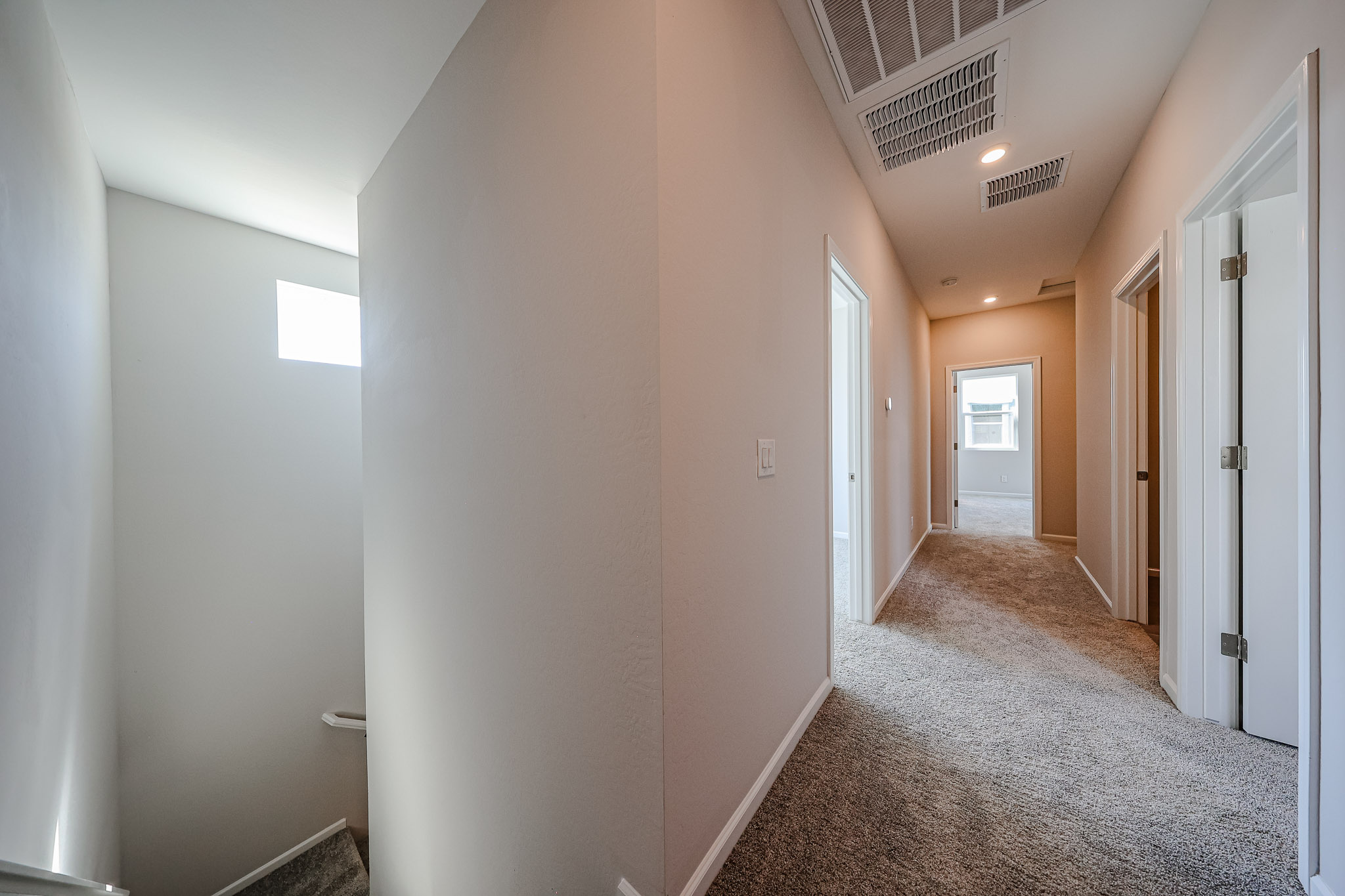 A hallway with white walls.