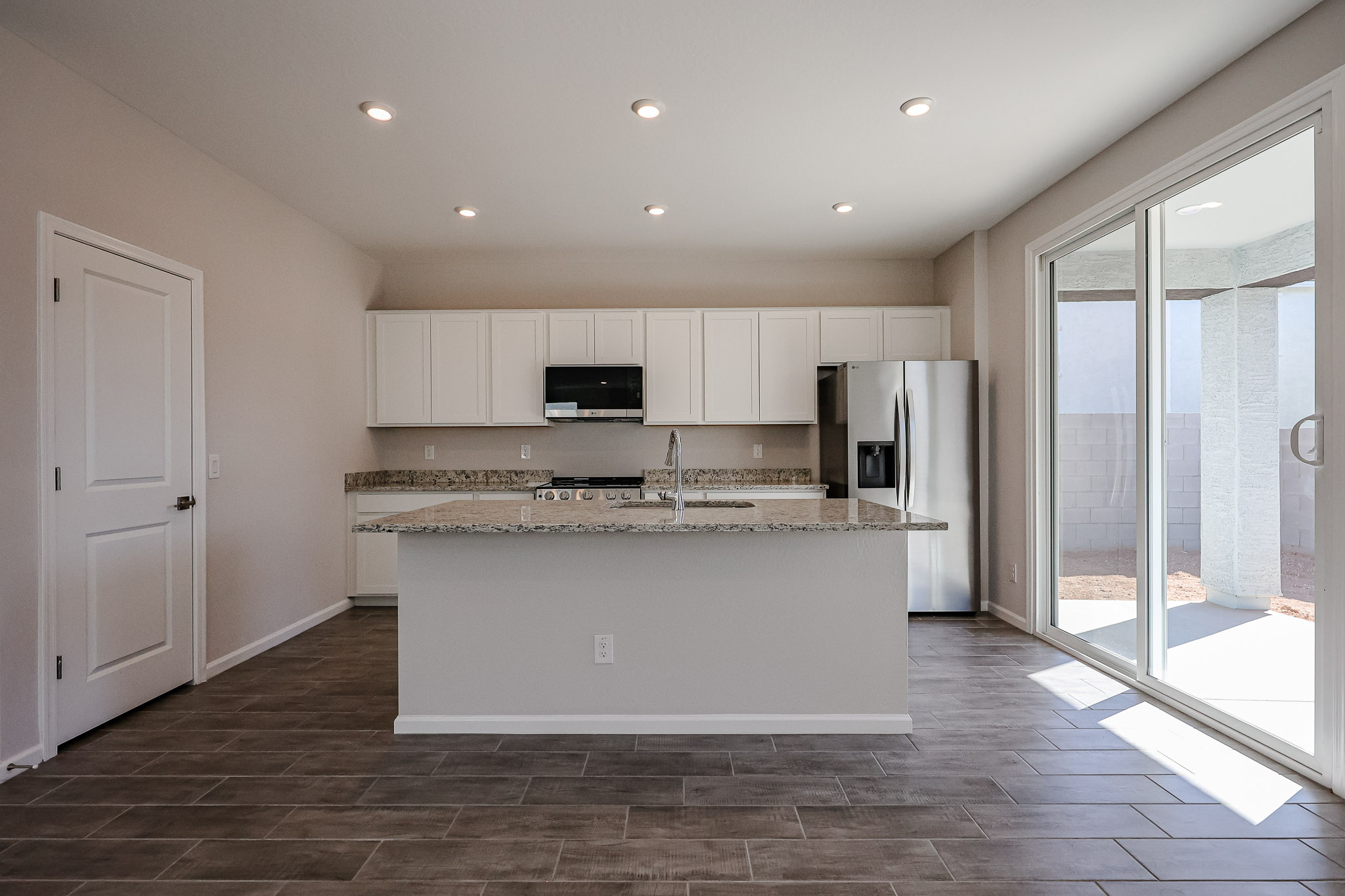 A kitchen with a large glass door.