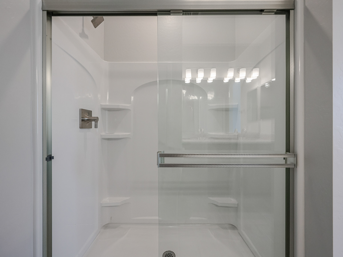 A shower with glass doors.