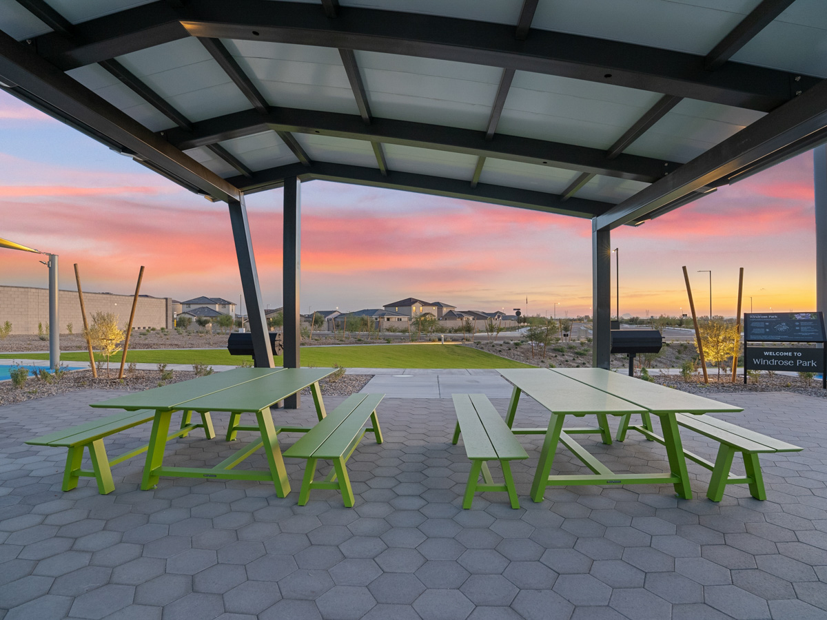 A patio with tables and chairs.