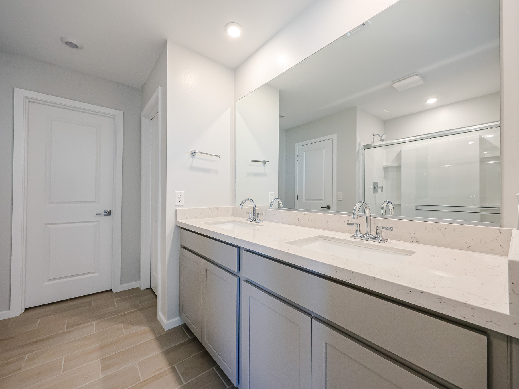 A bathroom with a large mirror.