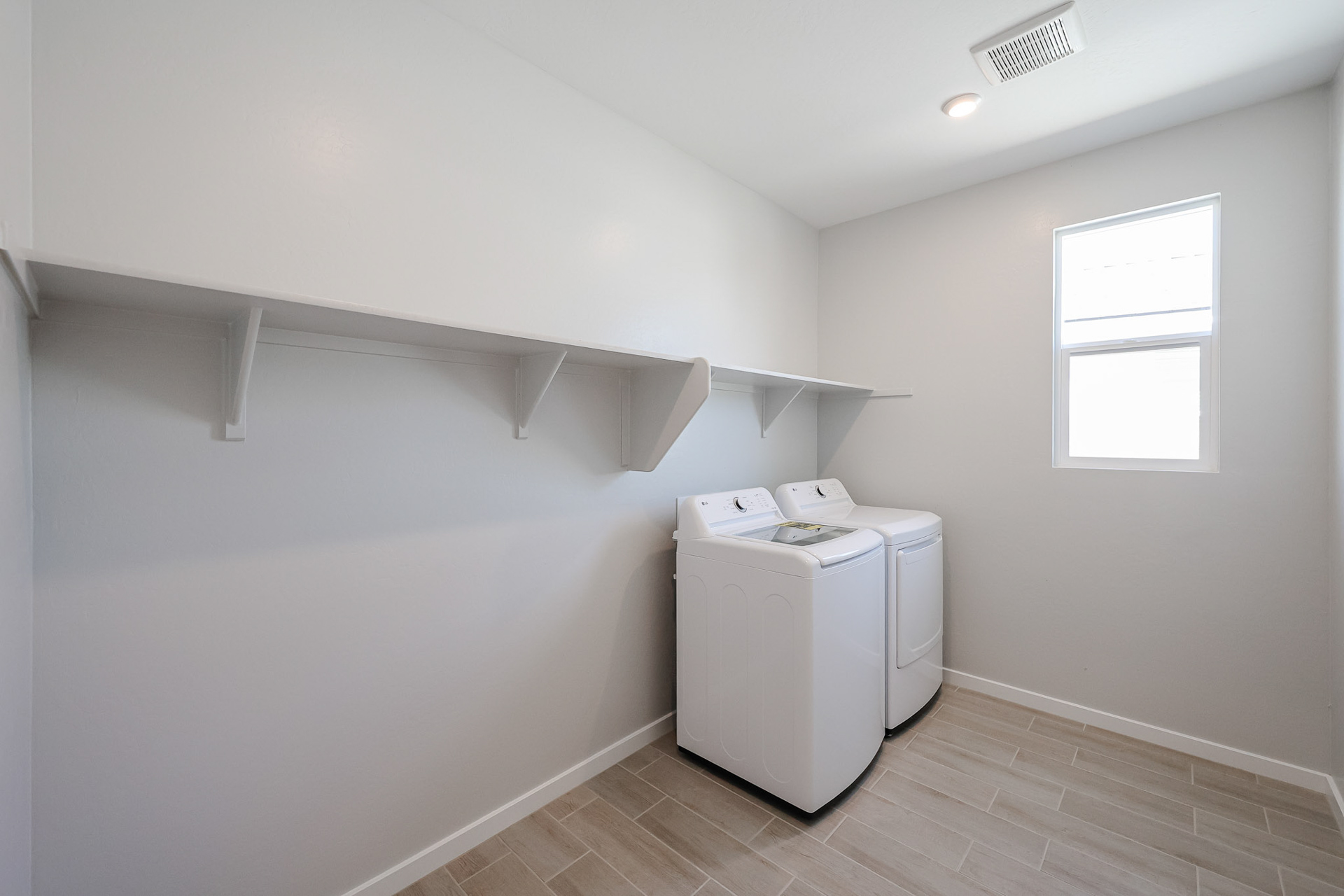 A room with a white wall and a white cabinet with a white machine.