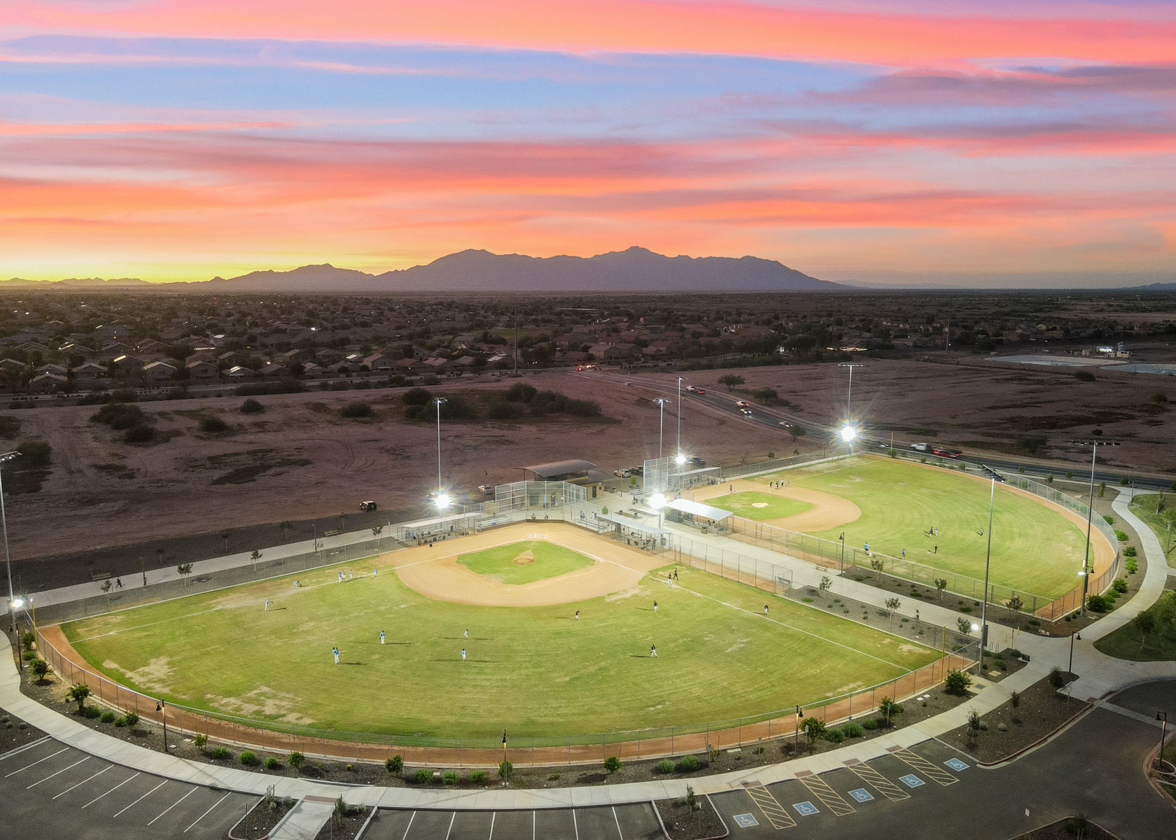 A large open field with a few people on it.