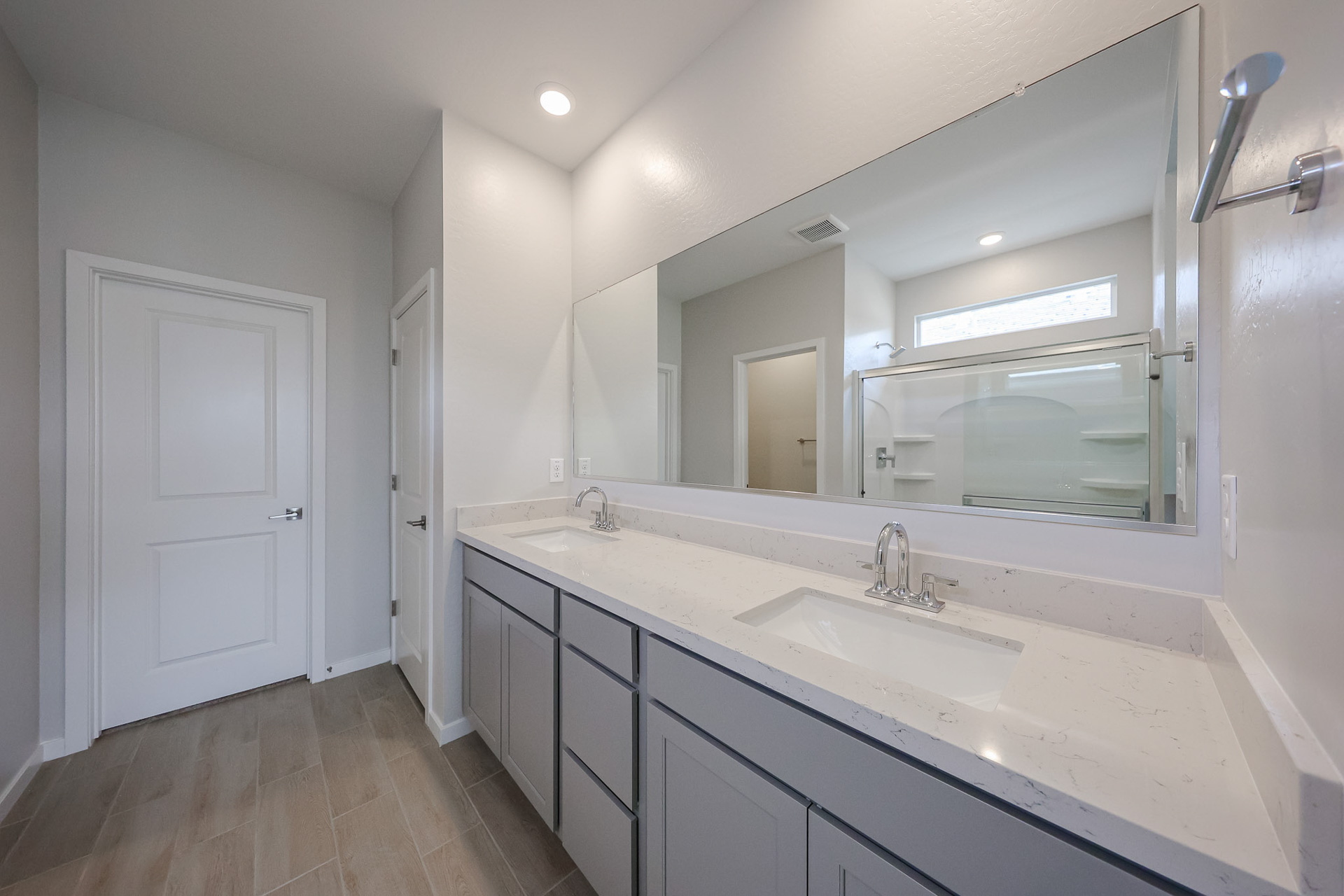 A bathroom with a large mirror.