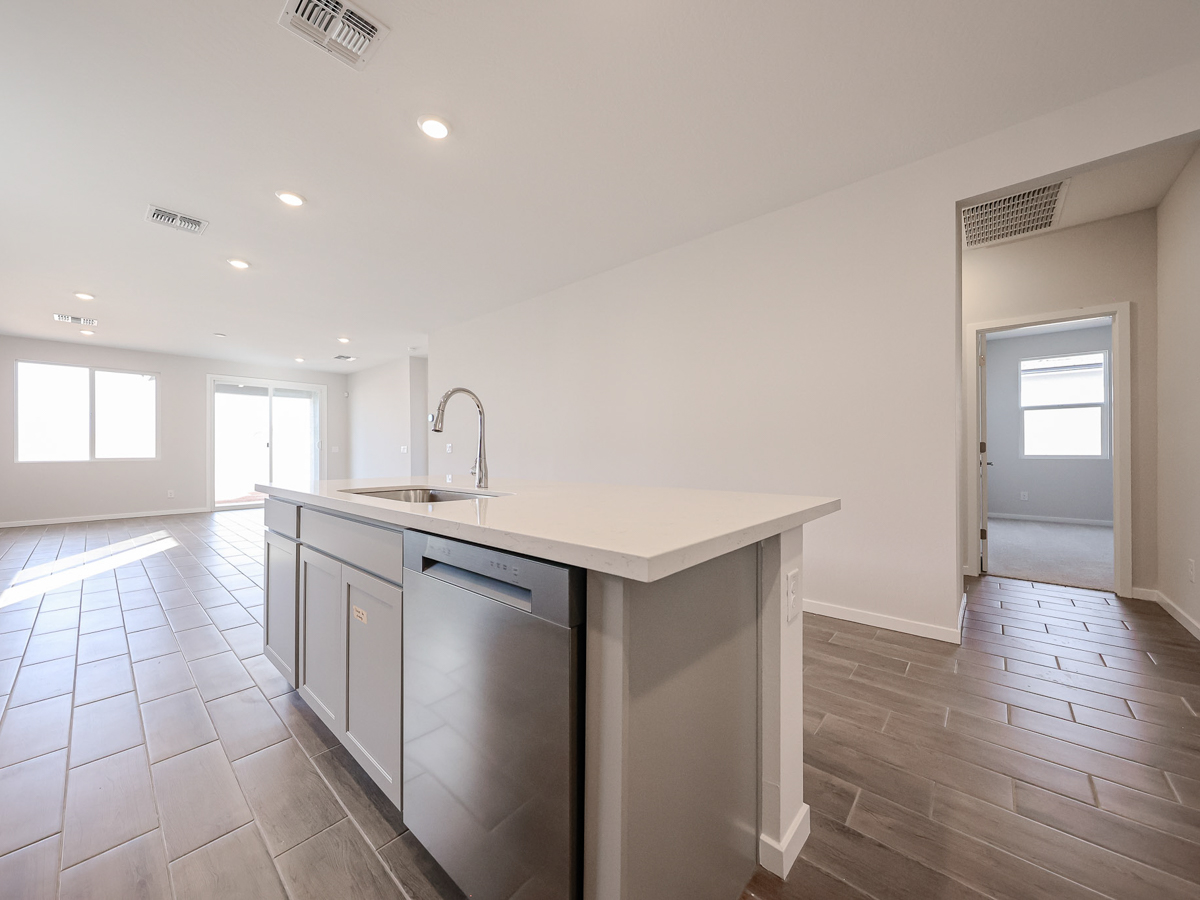 A kitchen with white cabinets.