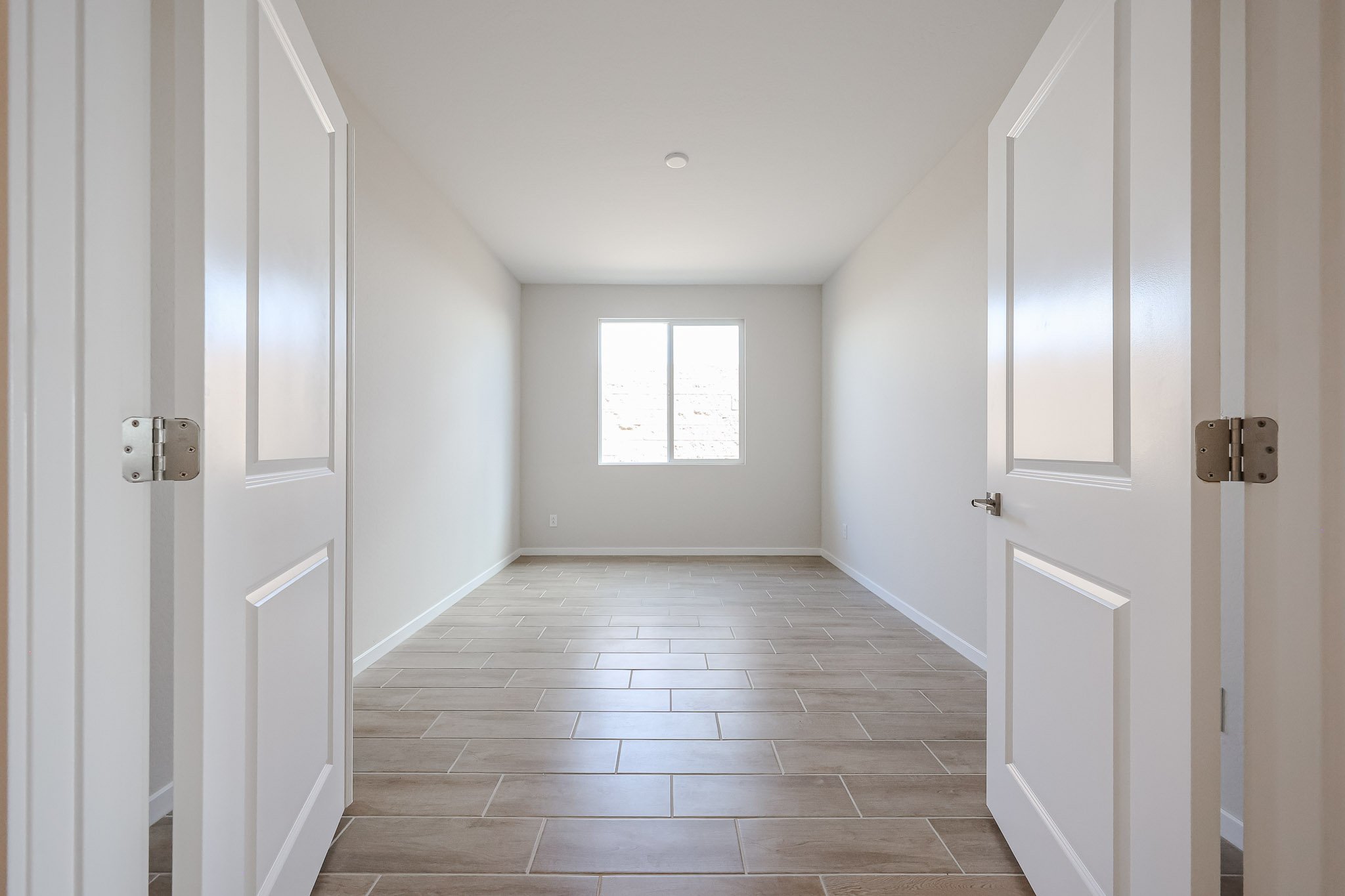 A hallway with white doors.