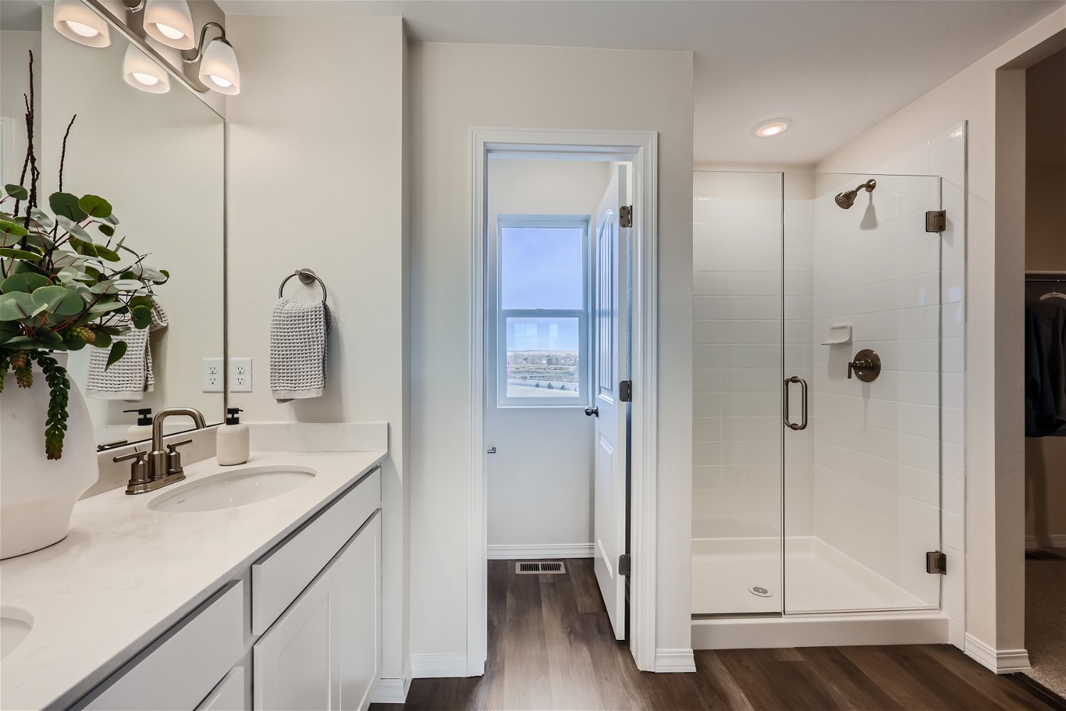 A bathroom with a sink and shower.