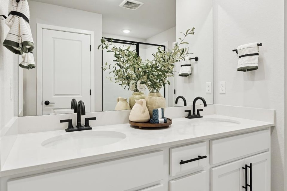 A bathroom with a sink and a mirror.