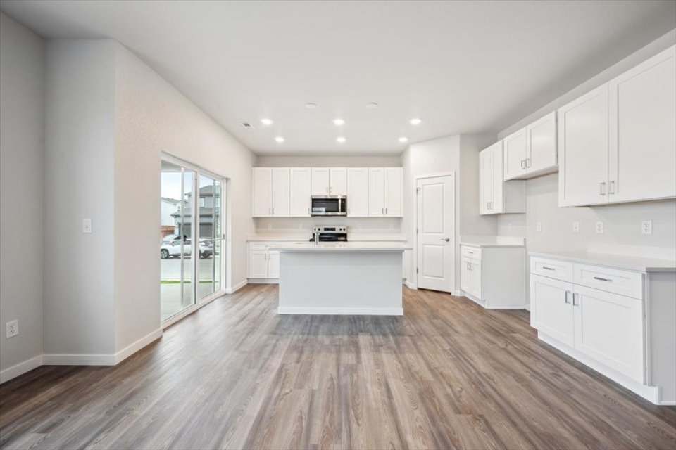 A kitchen with white cabinets.