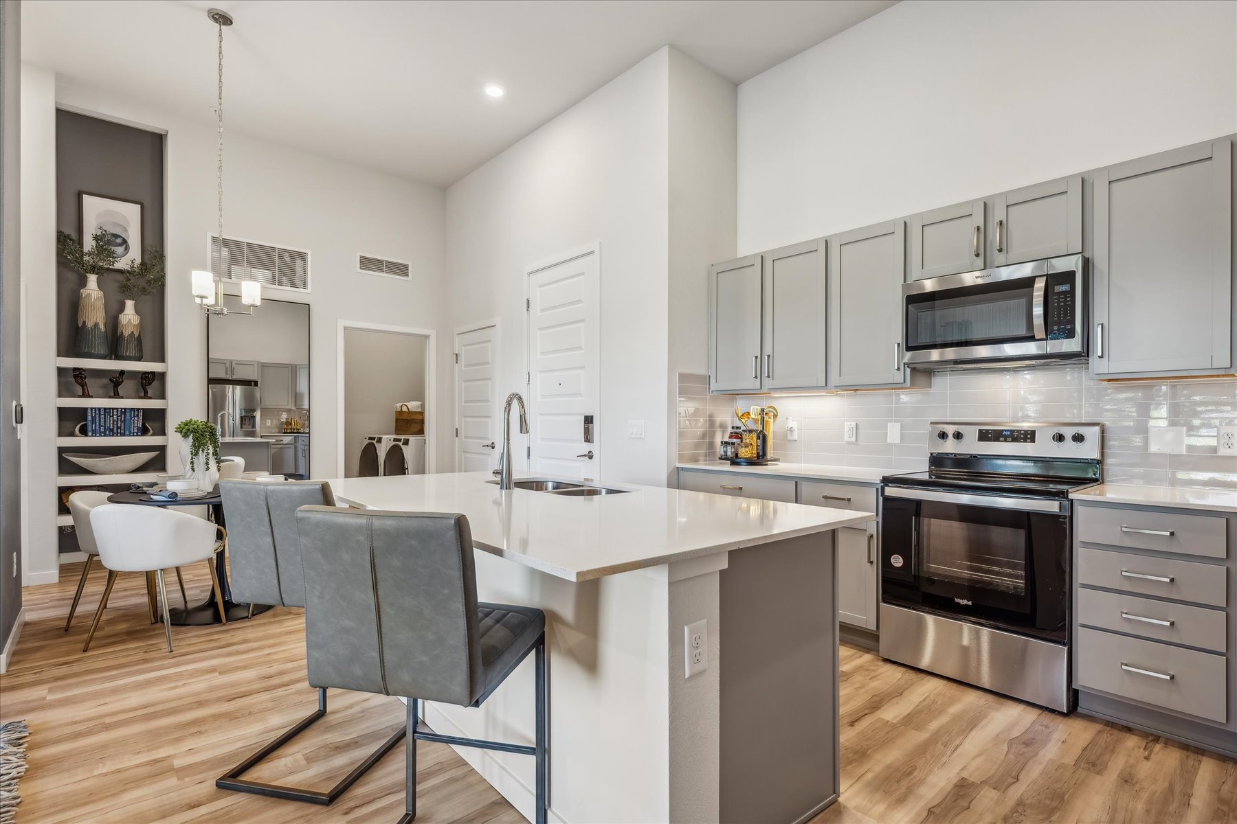 A kitchen with white cabinets.