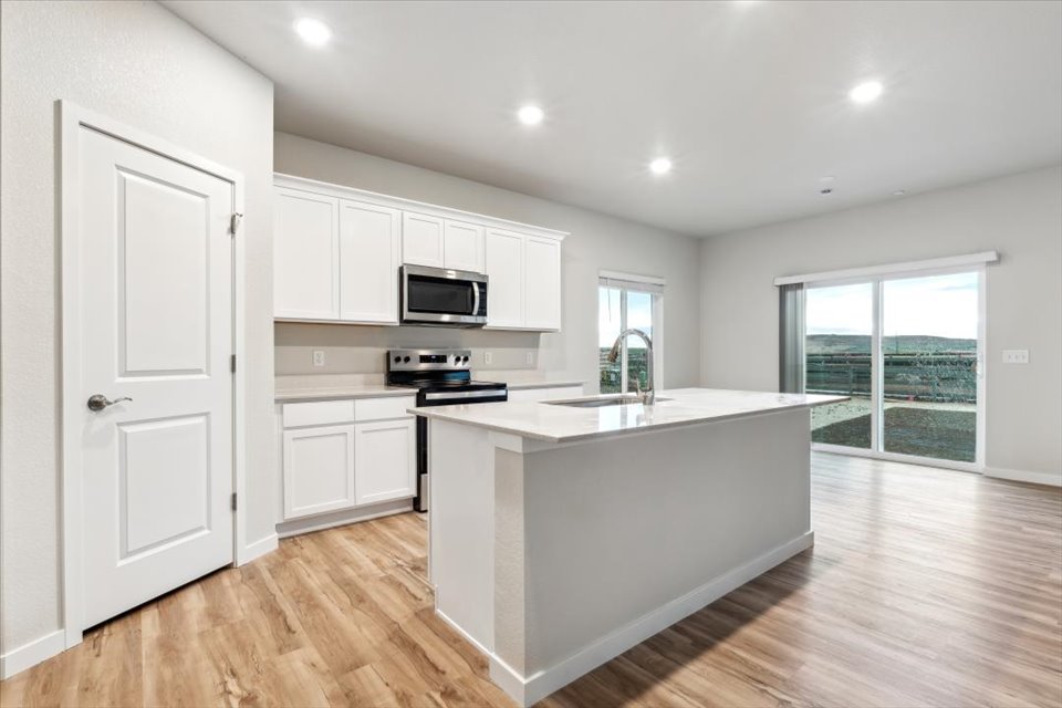 A kitchen with white cabinets.
