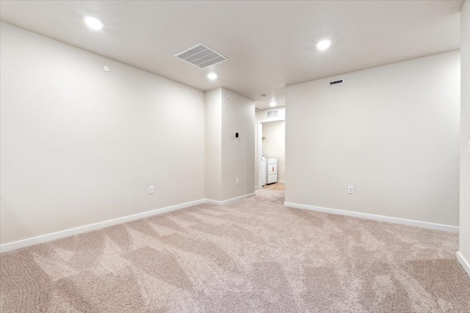 A room with a carpet and a carpet.