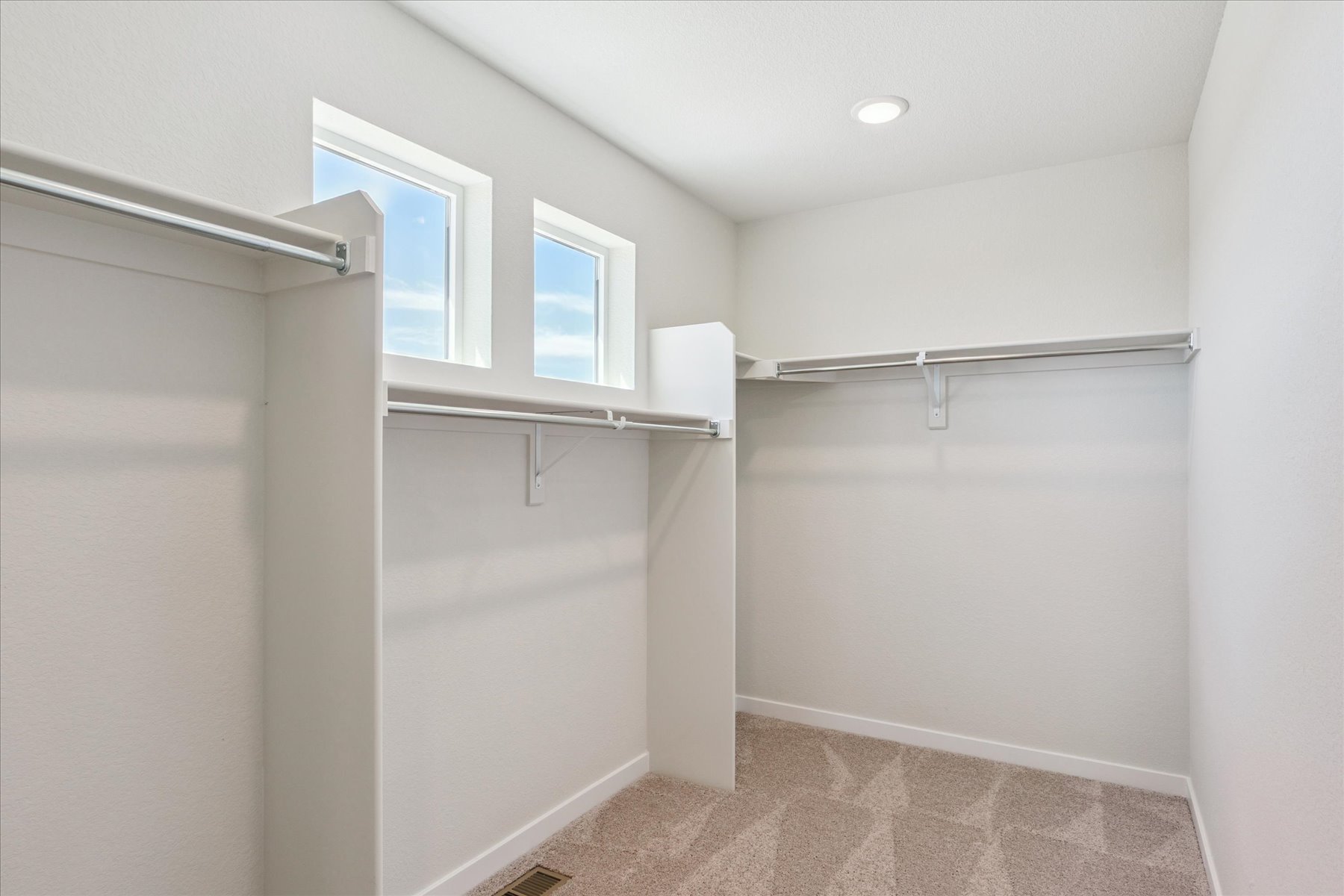 A white room with a shower and a window.