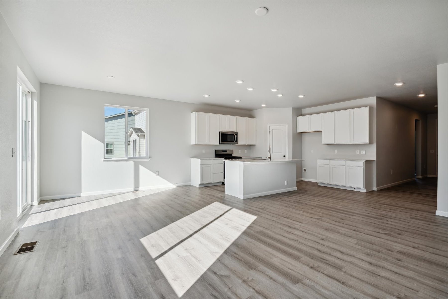 A large kitchen with white cabinets.