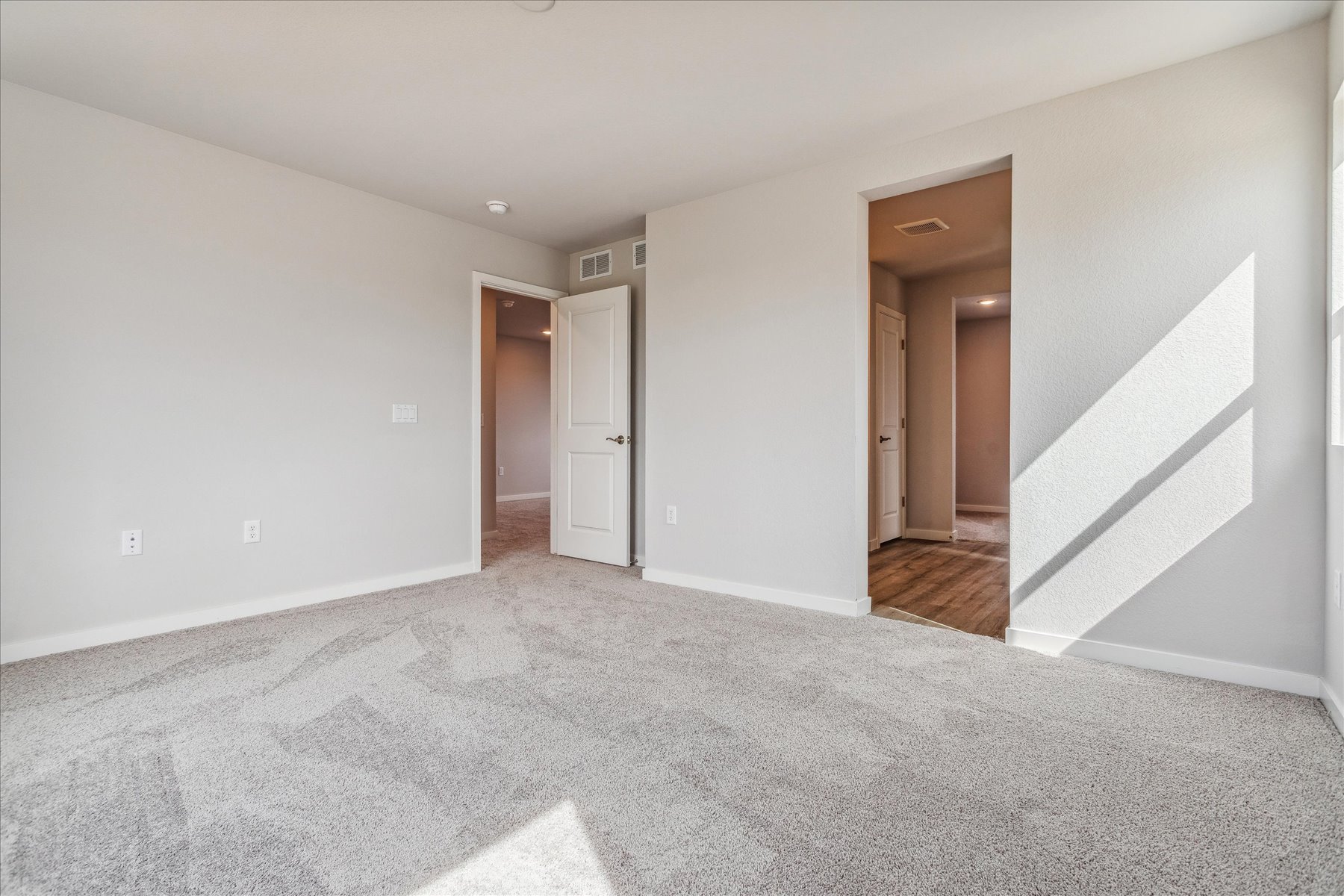 A hallway with white walls.