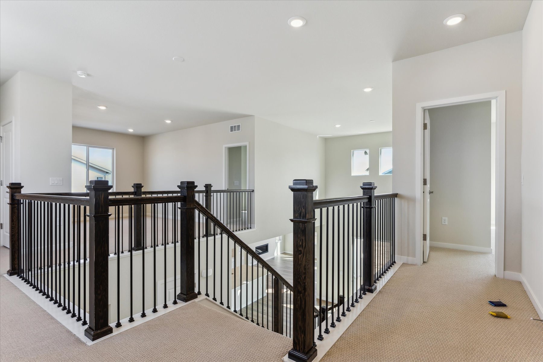 A large white room with black railings and white walls.