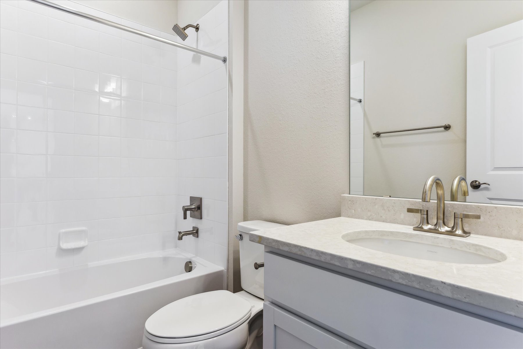 A bathroom with a sink toilet and bathtub.