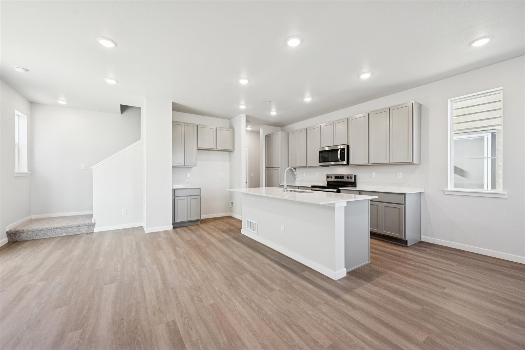 A kitchen with white cabinets.