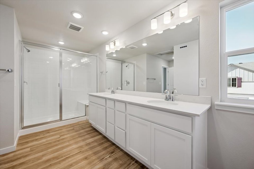 A bathroom with a large mirror.