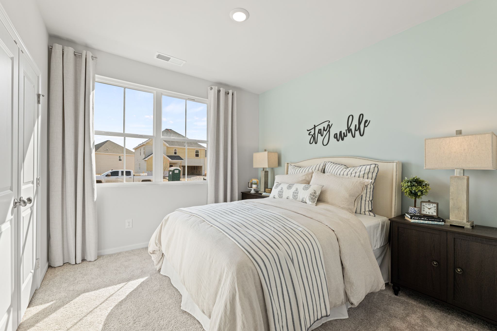 A bedroom with a large window.