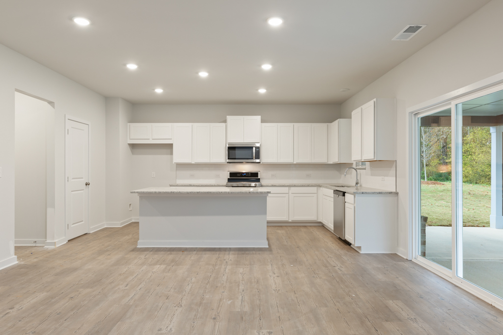 A kitchen with white cabinets.