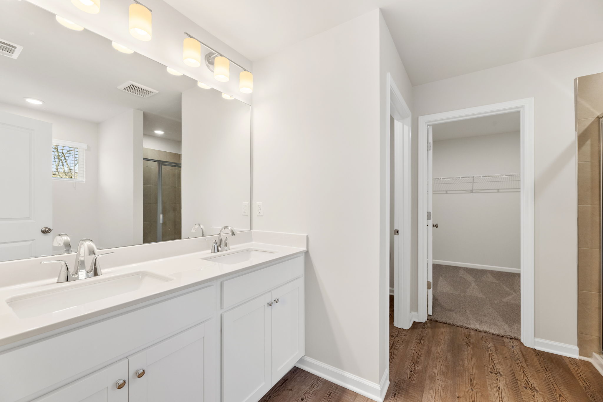A bathroom with white cabinets.