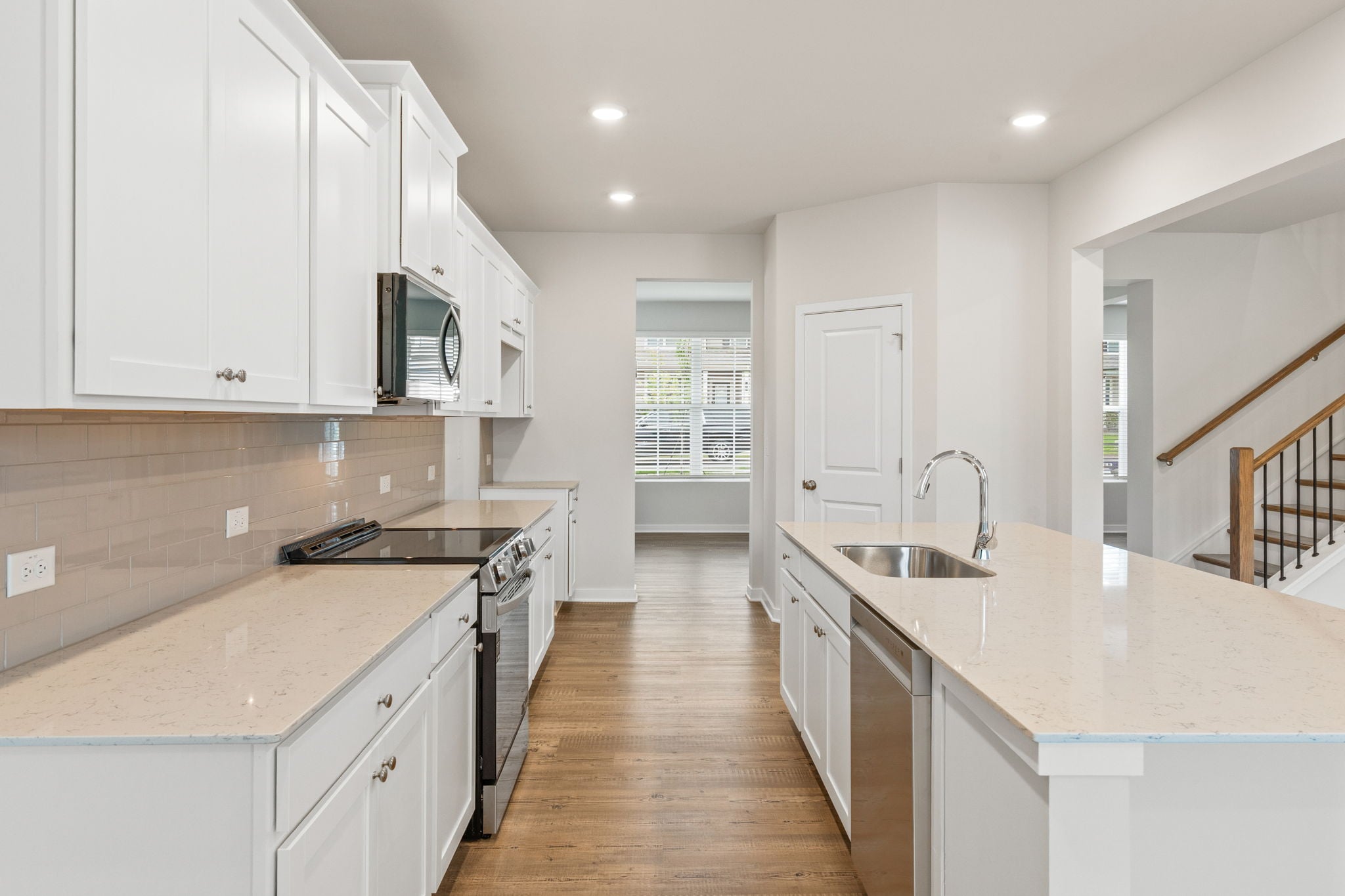 A kitchen with white cabinets.