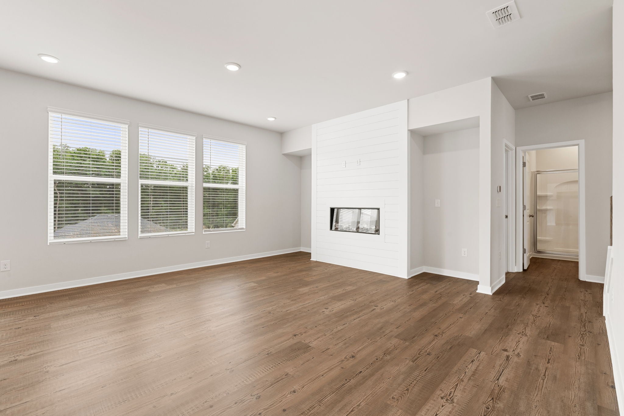 A room with a wood floor and white walls.