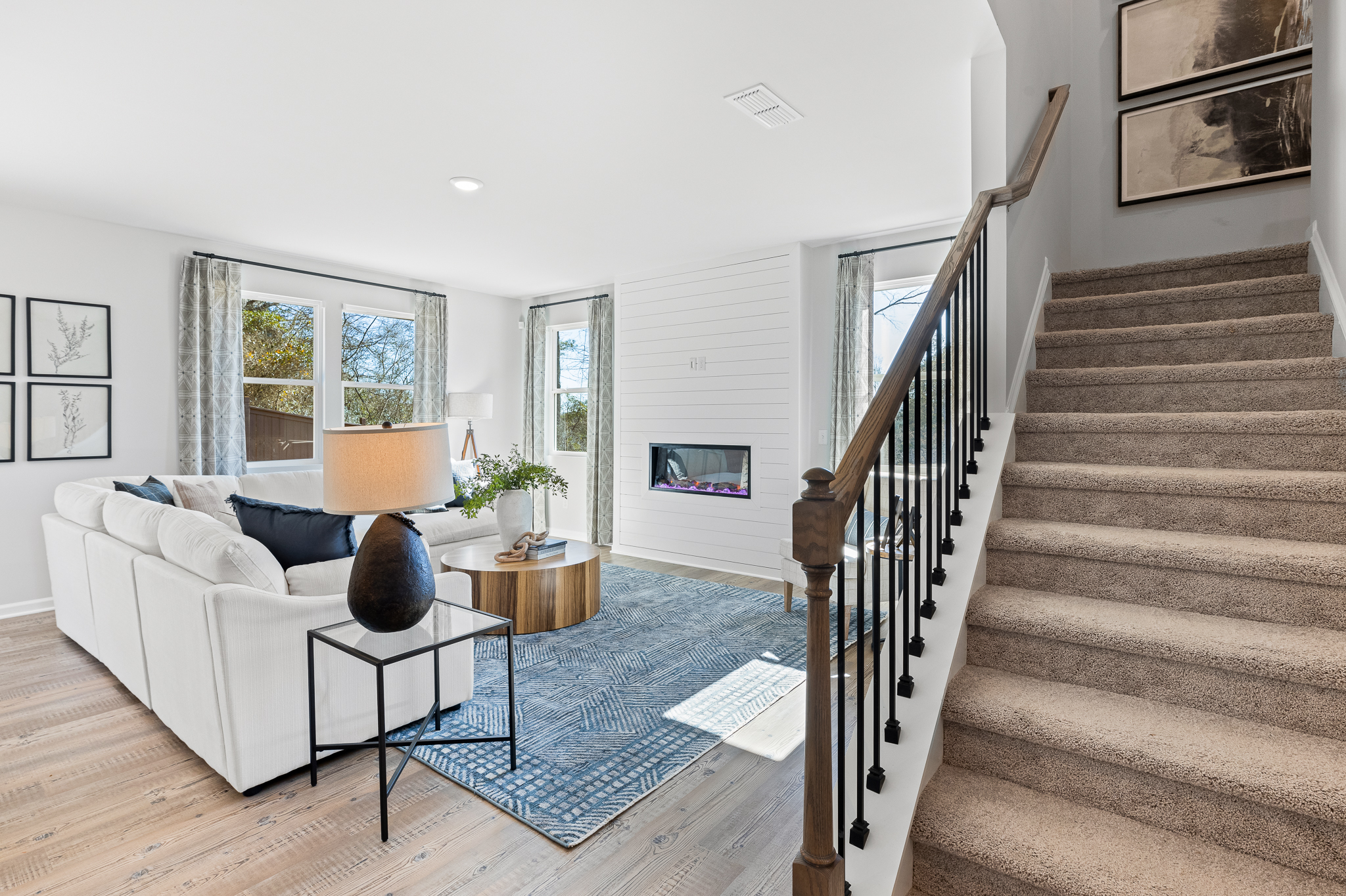A living room with a staircase.