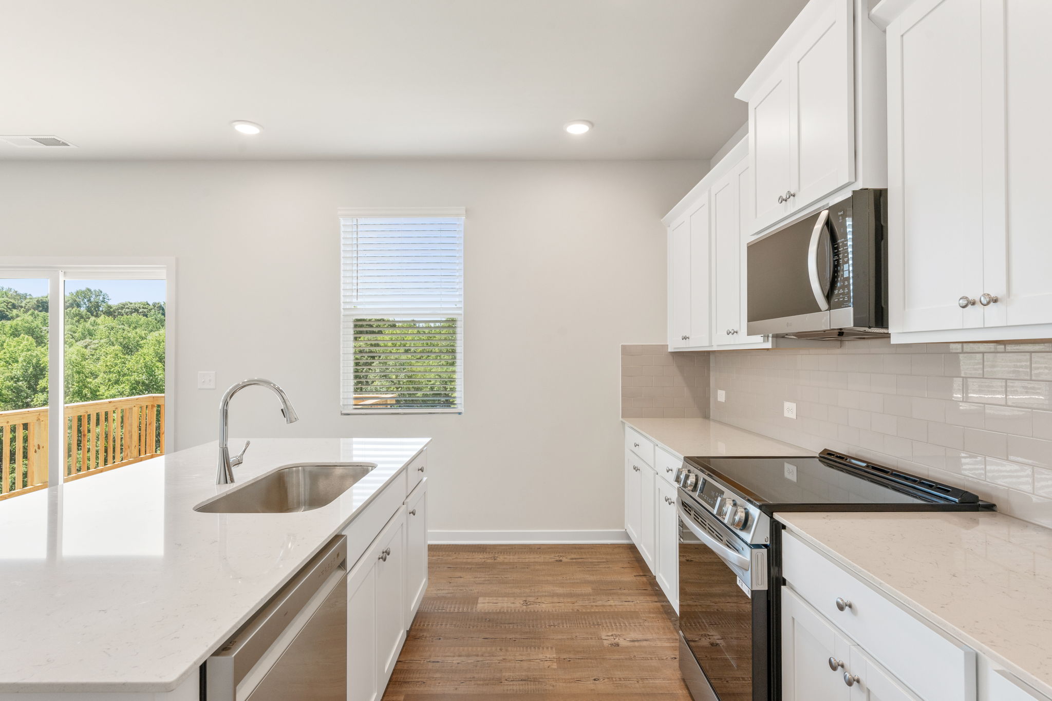 A kitchen with white cabinets.