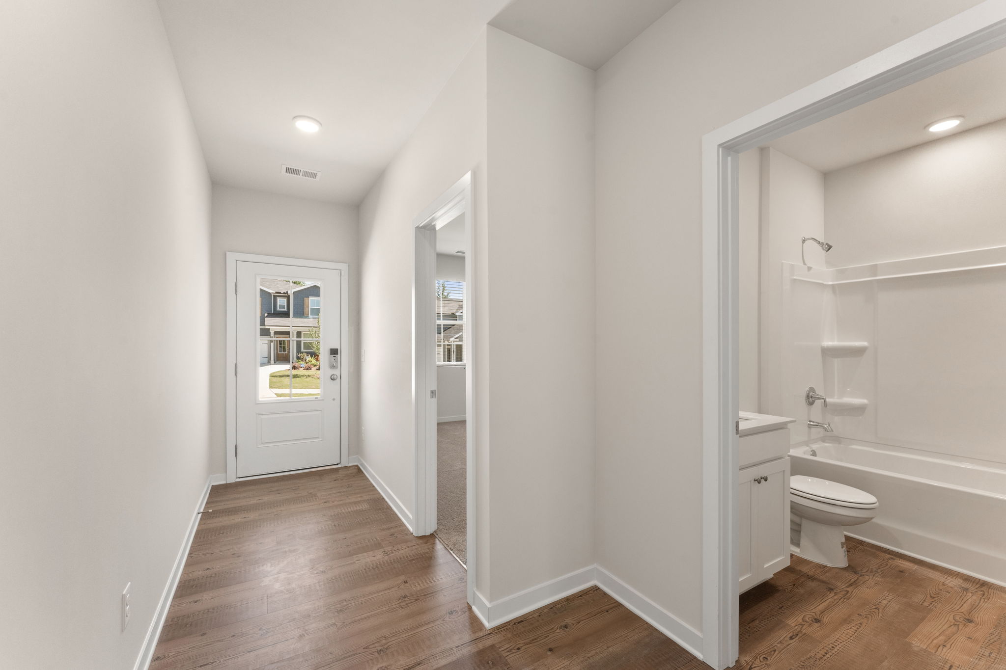 A bathroom with a wood floor.