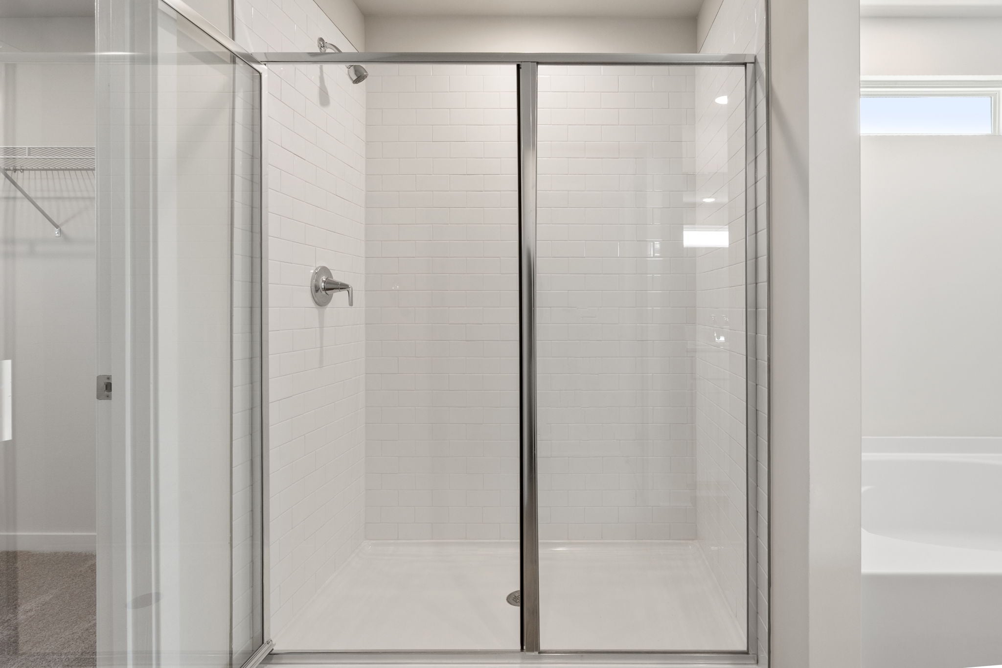 A shower with glass doors.
