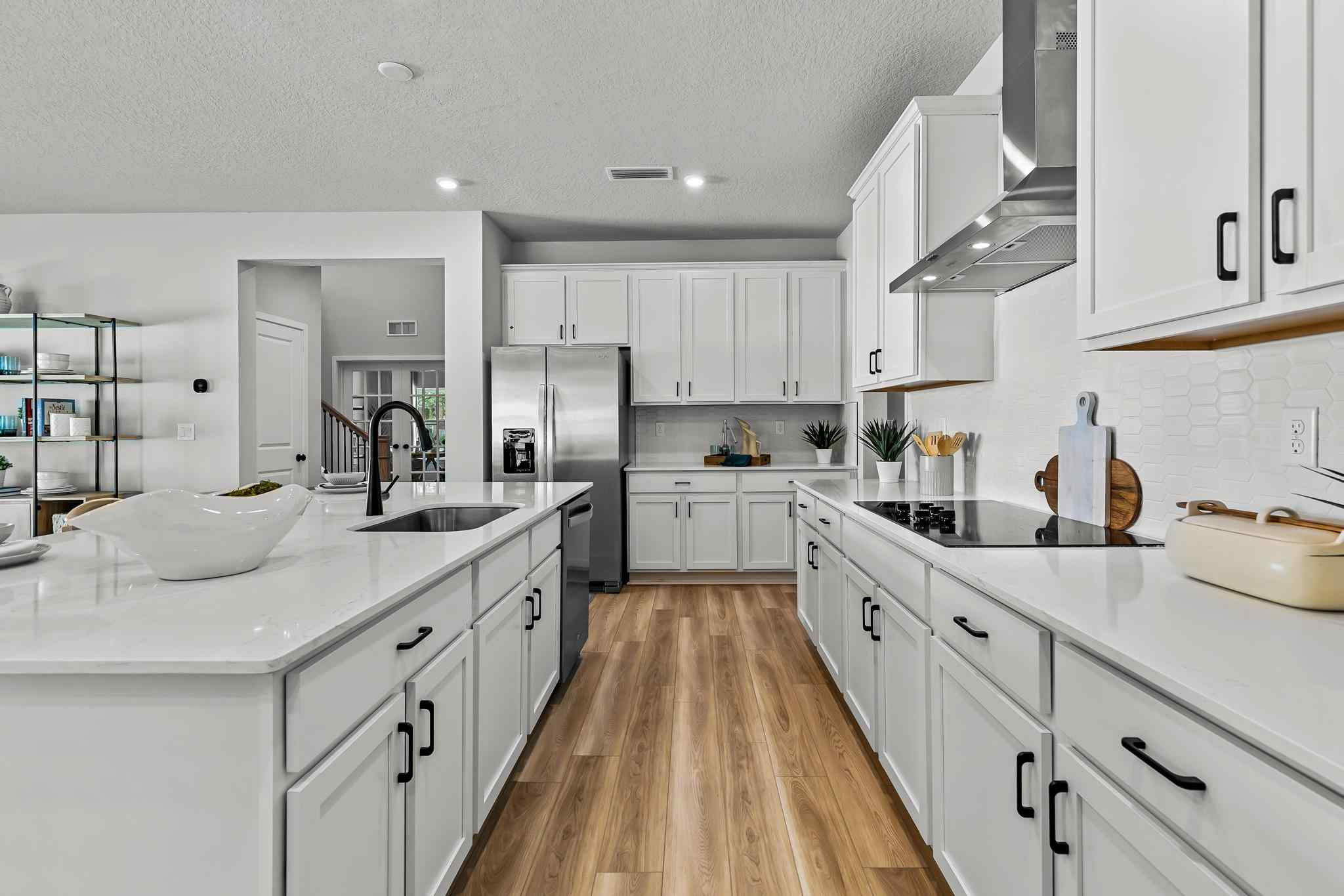 A kitchen with white cabinets.