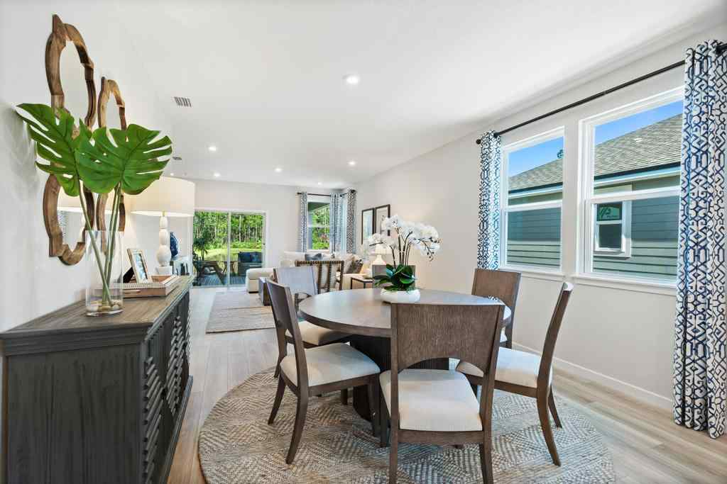 A dining room with a table and chairs.