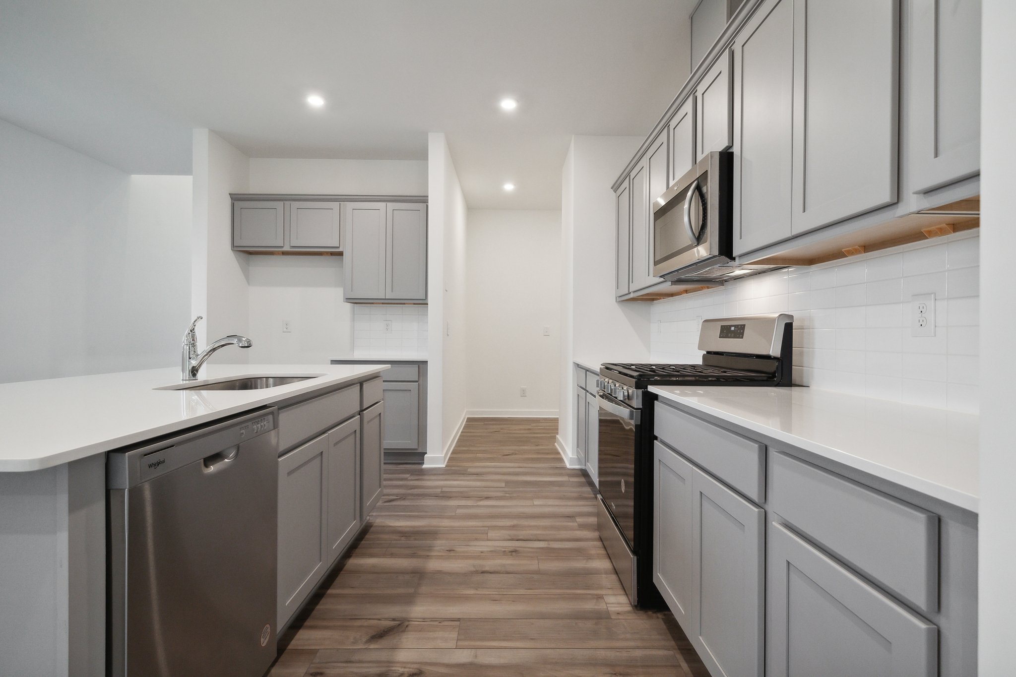 A kitchen with white cabinets.