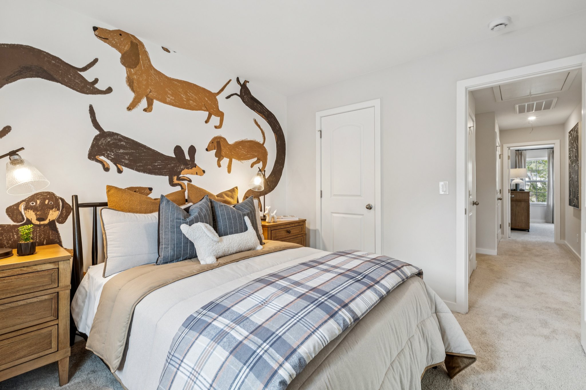 A bedroom with a bed and a wall with fish on it.