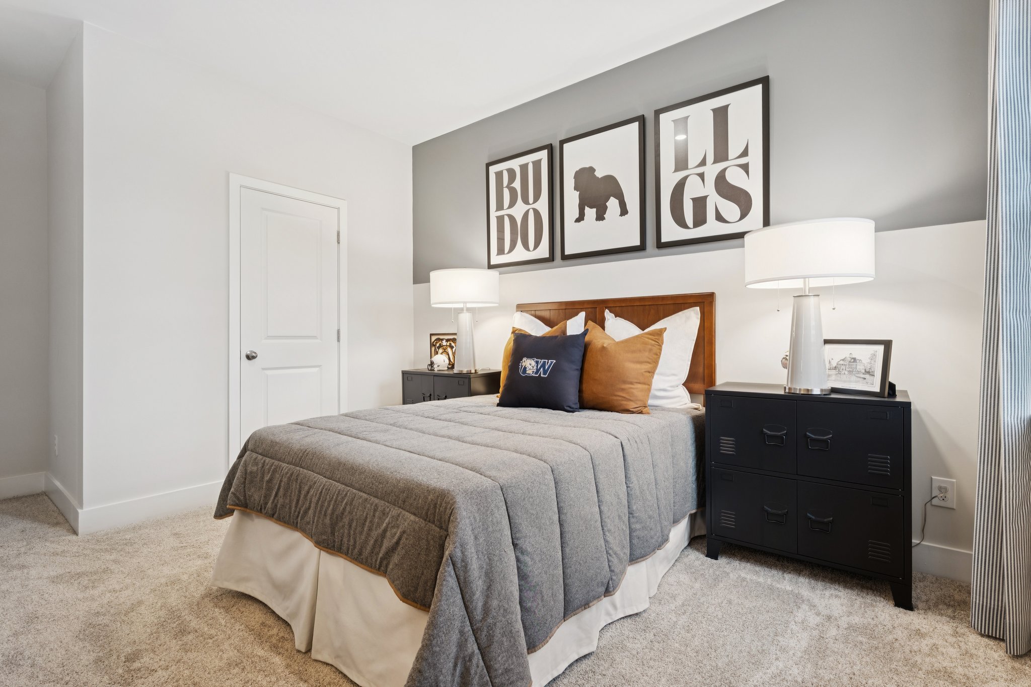 A bedroom with a bed and lamps.