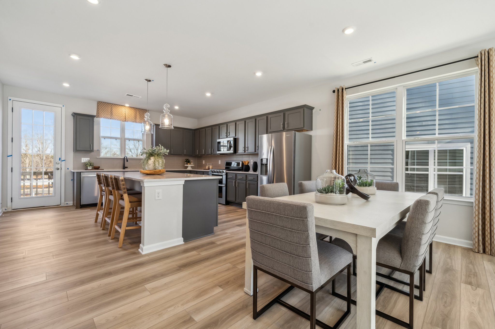 A large kitchen with a dining table.